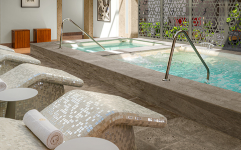 a pool with a white towel and a white chair