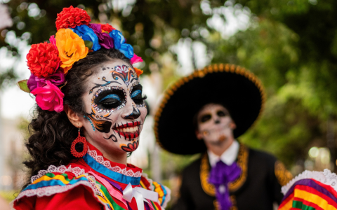 a woman with face paint and flowers in her hair