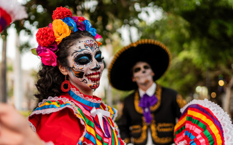 a woman with face paint and a man in a garment