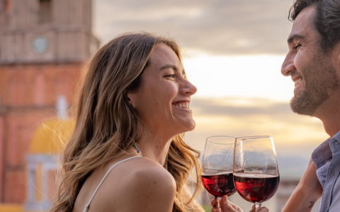 a woman holding wine glasses