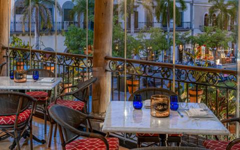 a table and chairs on a balcony
