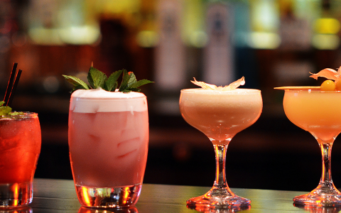 two glasses with drinks on a table
