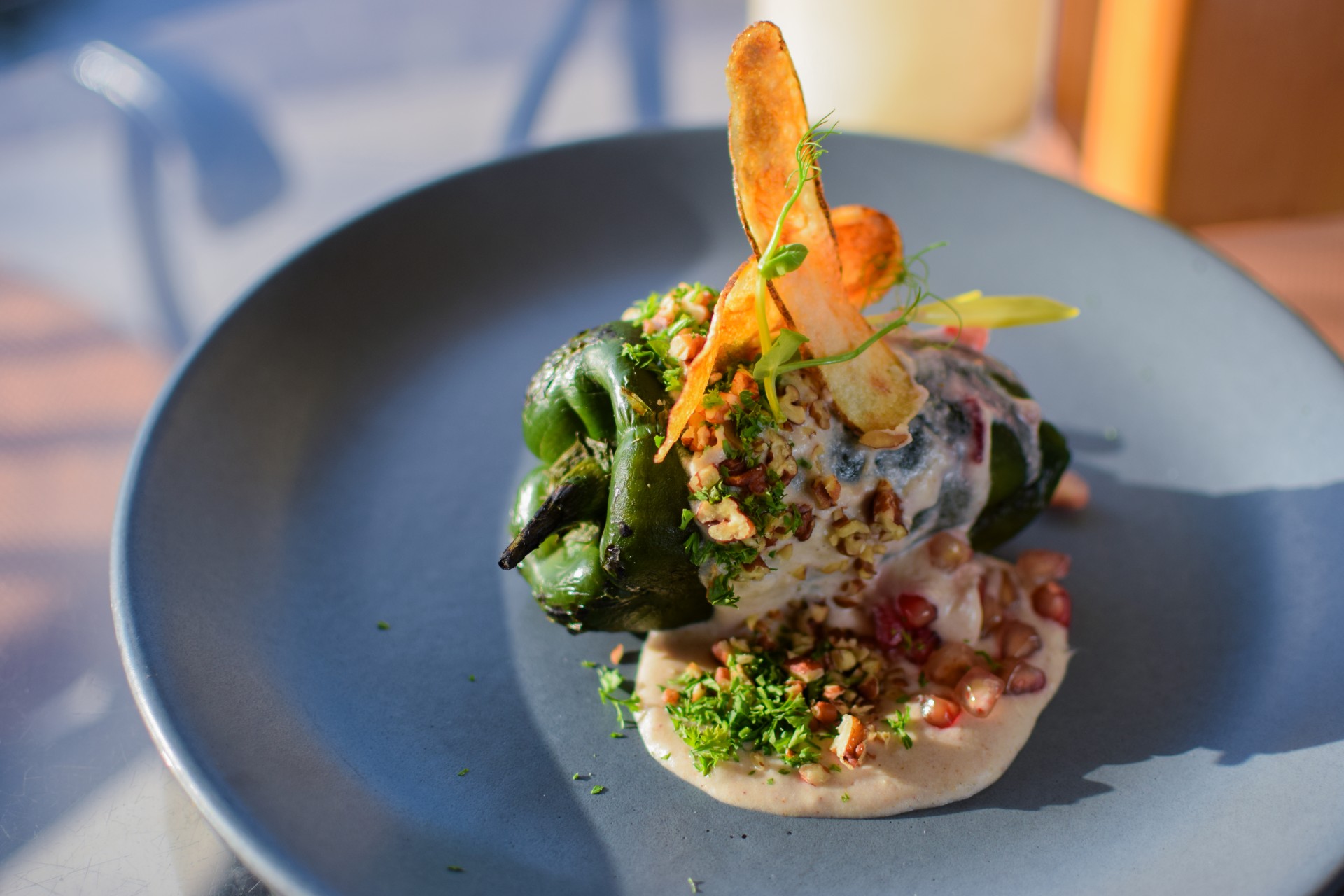 a green pepper wrapped in a green pepper with a white sauce and toppings