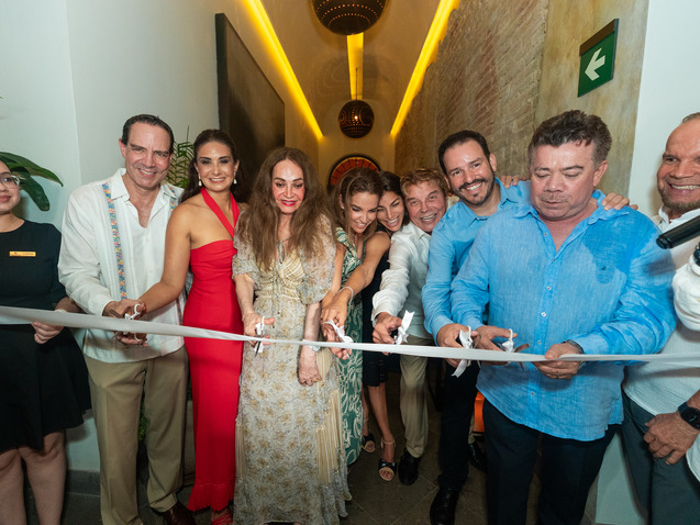 a group of people cutting a ribbon