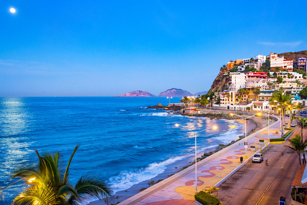 a beach with buildings and a body of water