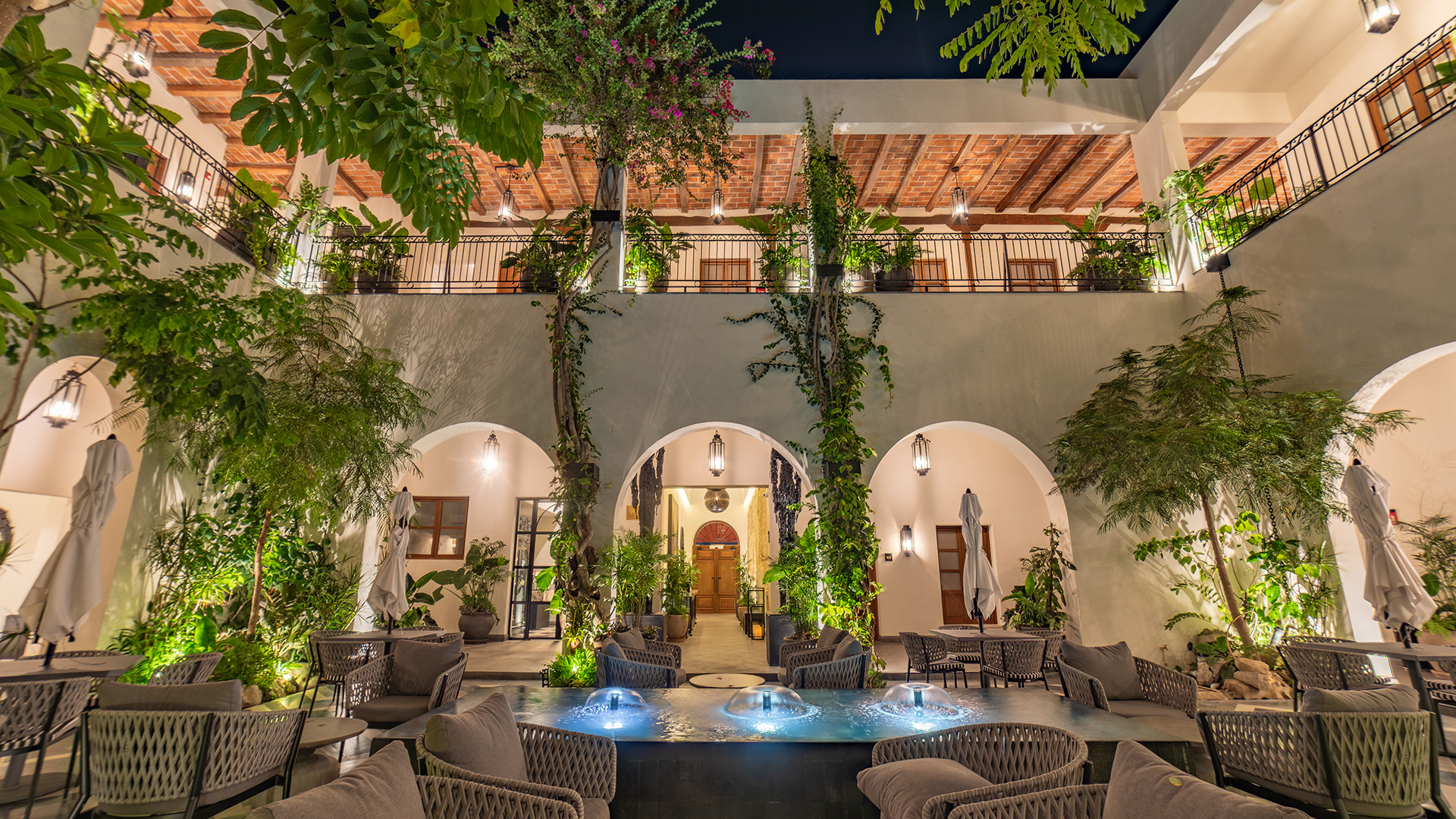 a courtyard with a fountain and chairs