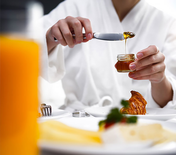 a chef pouring a sauce into a jar