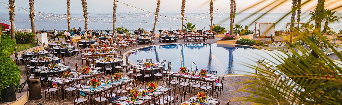 a pool with tables and chairs and flowers