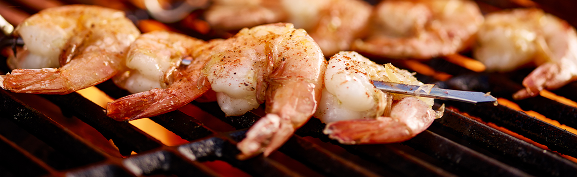 shrimp on a grill with a couple of shrimp