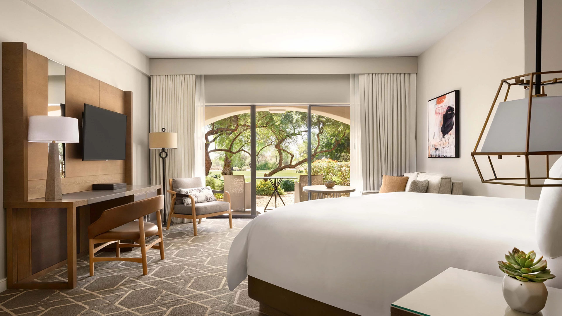 a room with a large bed and a television