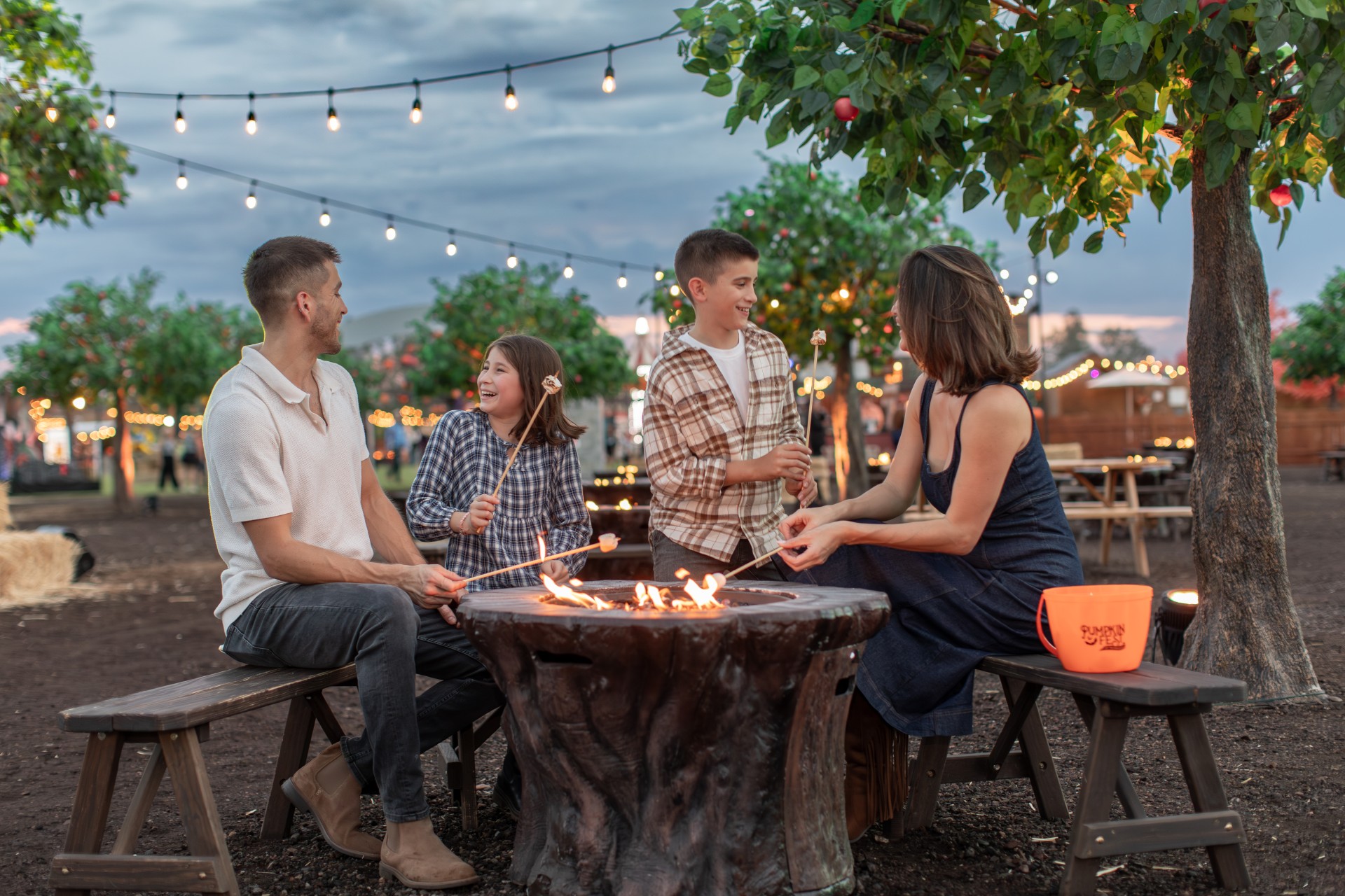 a group of people sitting around a fire pit
