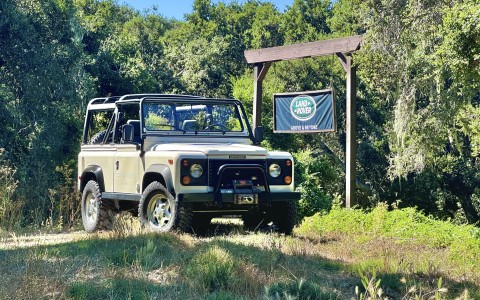 a Land Rover parked in the woods