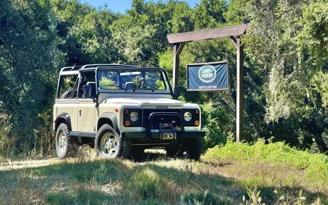 a Land Rover parked in the woods