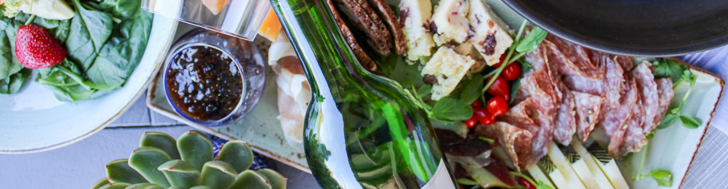 a bottle of wine next to food