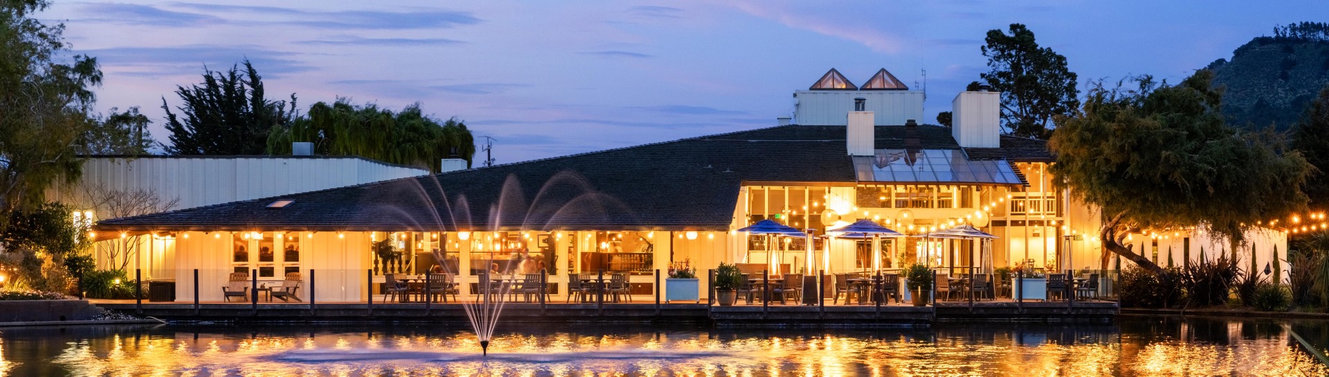 a building with a fountain and tables and chairs