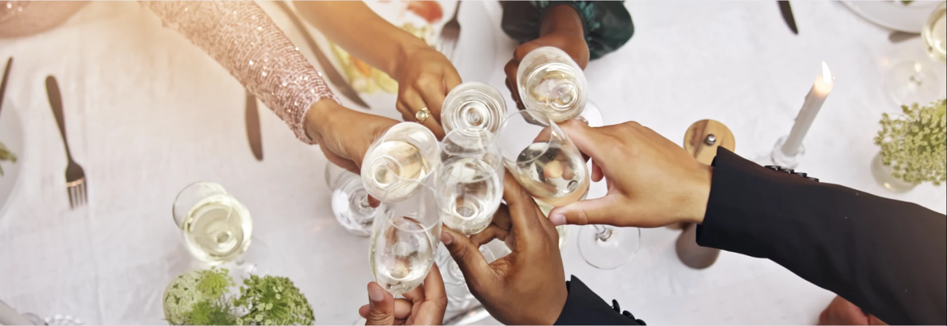 a group of hands holding wine glasses