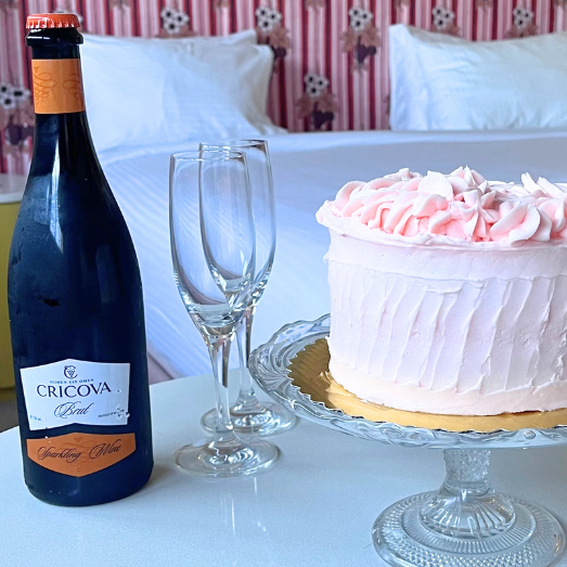 a bottle of wine next to a cake - Cheers Package