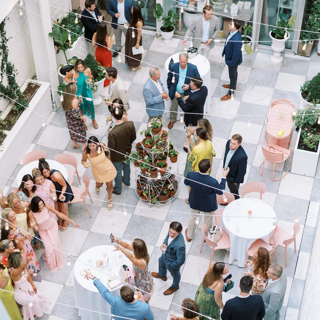 a group of people at a party in a courtyard