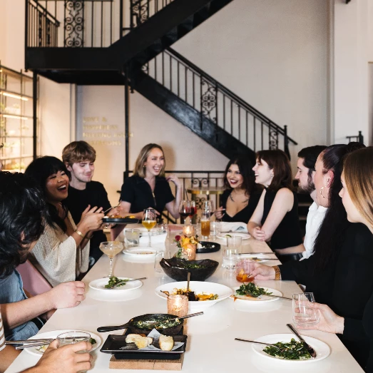 a group of people sitting around a table