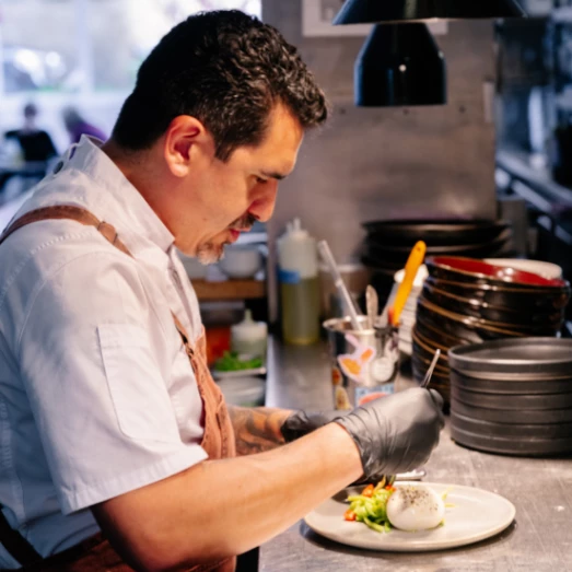 Chef Felipe in The Lobby Bar kitchen preparing dinner