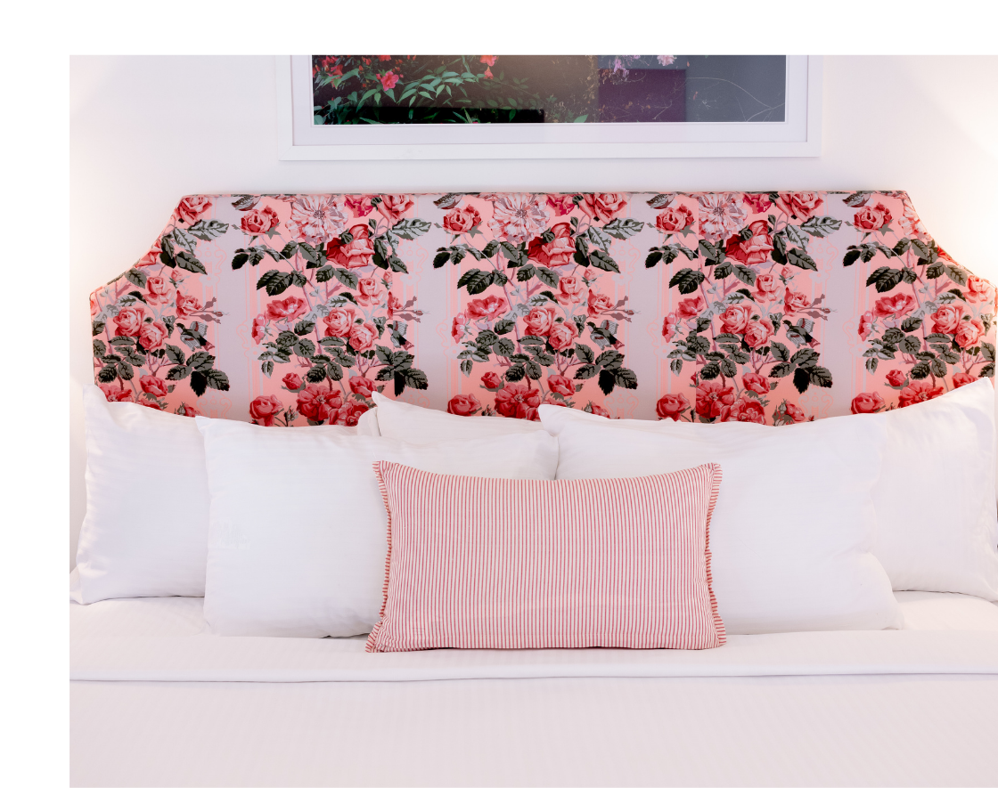 a bed with a floral headboard