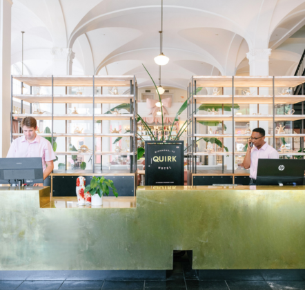 a group of men at a hotel reception desk