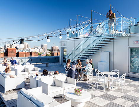 people hanging out in a rooftop on a sunny day