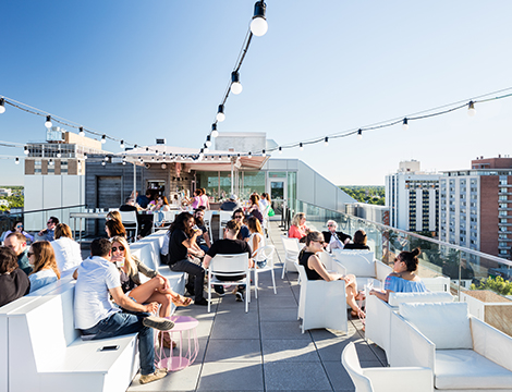 people hanging out in a rooftop on a sunny day