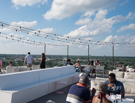 people hanging out in a rooftop on a sunny day