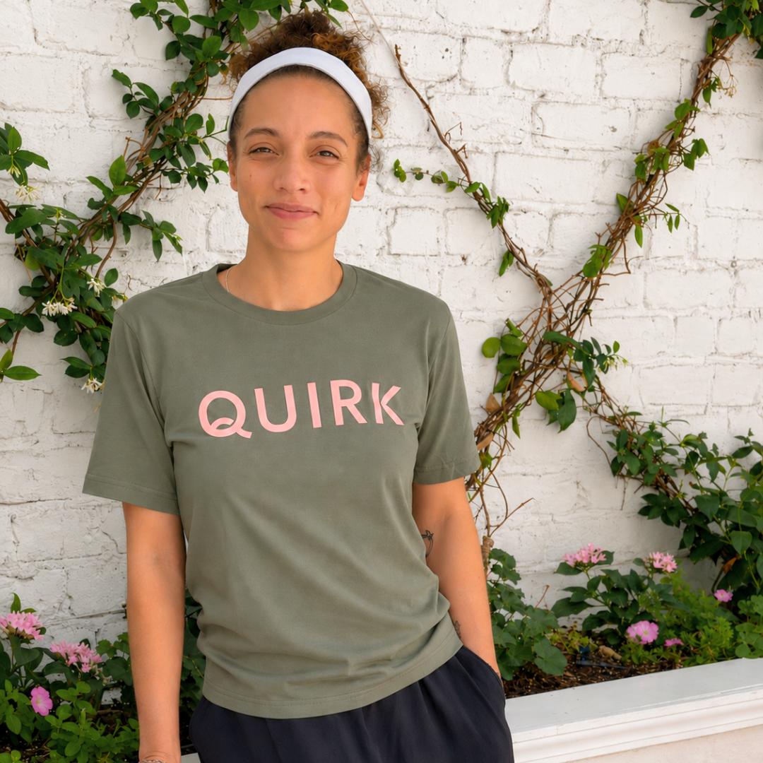 a Quirk Model standing in front of a Quirk Courtyard's vine brick wall