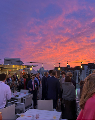 a group of people standing on Q rooftop