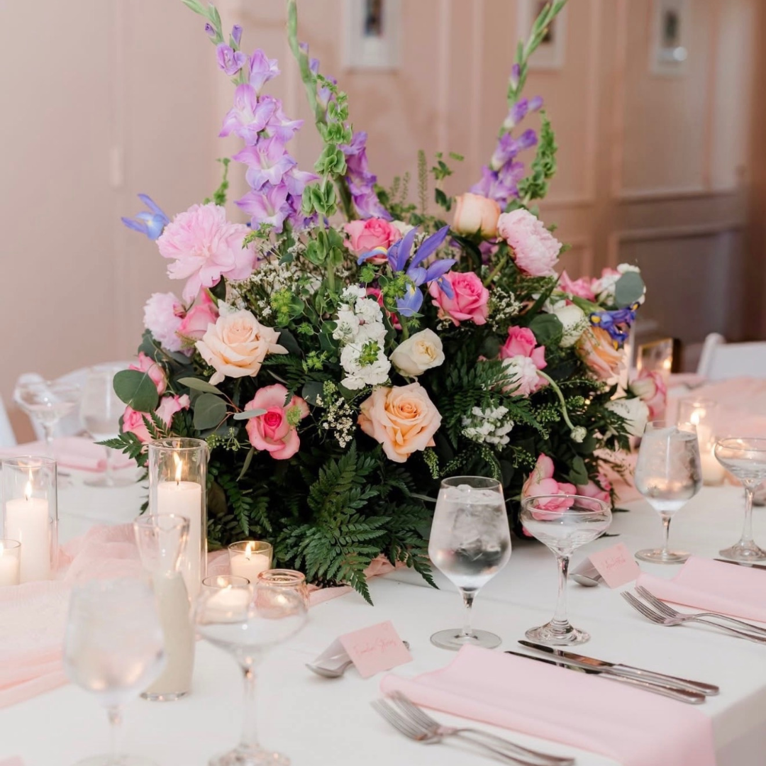 a table set with flowers and candles