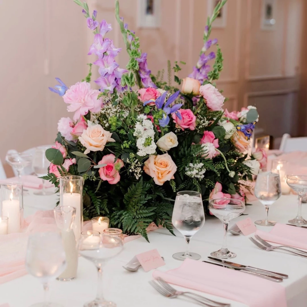 a table set with flowers and candles
