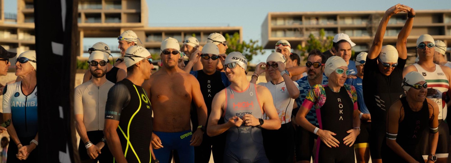 a group of people in swimsuits on a beach