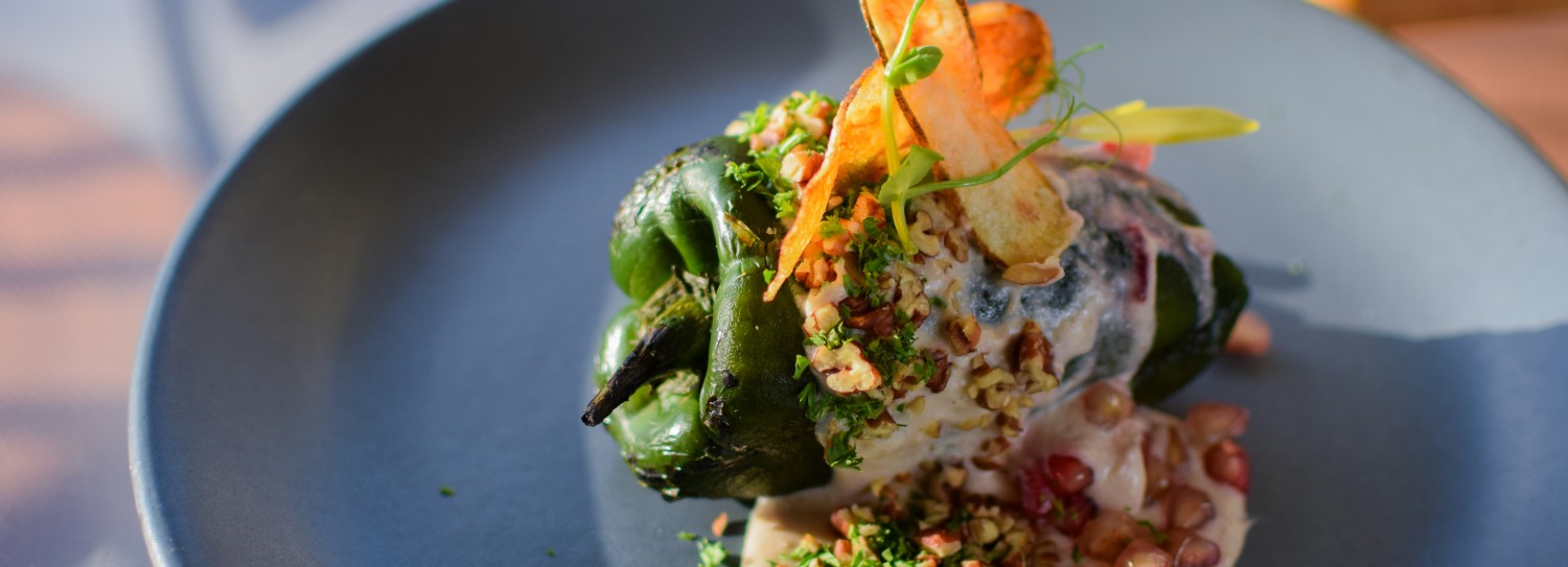 a green pepper wrapped in a green pepper with a white sauce and fries