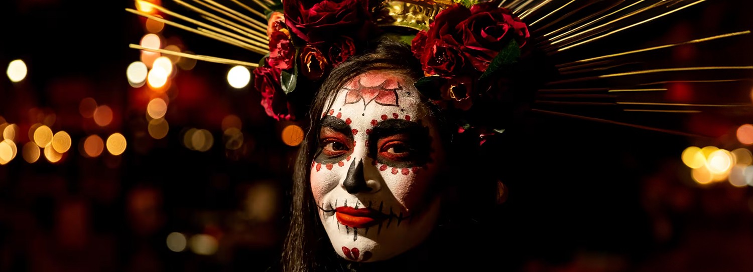 a woman with face paint and roses in her hair