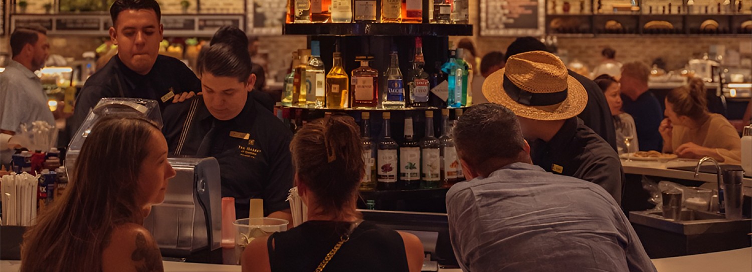 a group of people sitting at a bar