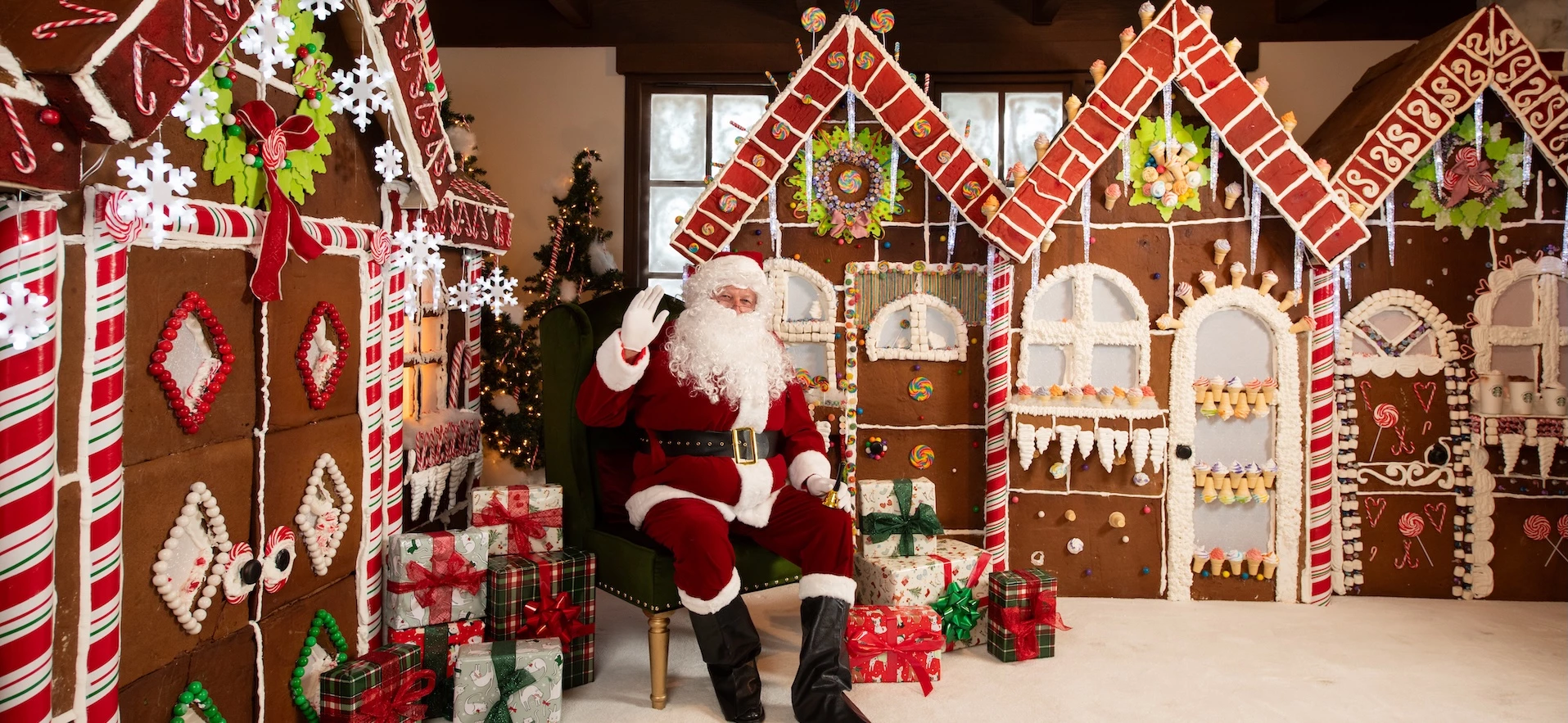 a man in a garment sitting in a chair with presents