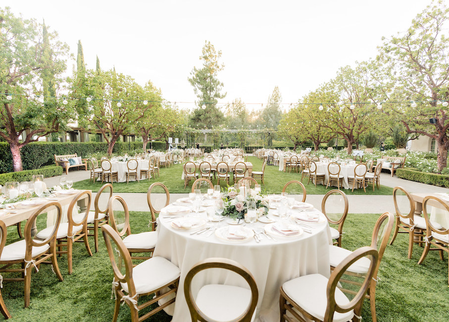 a round white table set up for a wedding reception