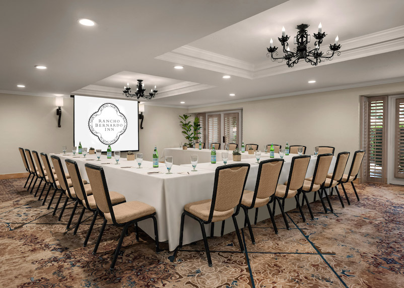 a room with a long table and chairs
