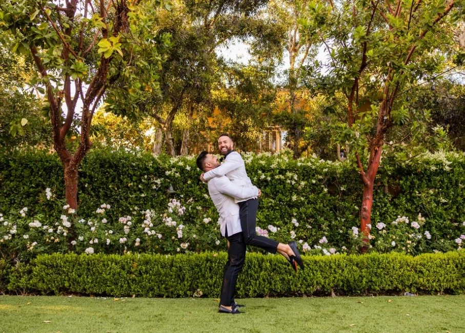 a man and woman dancing in a park