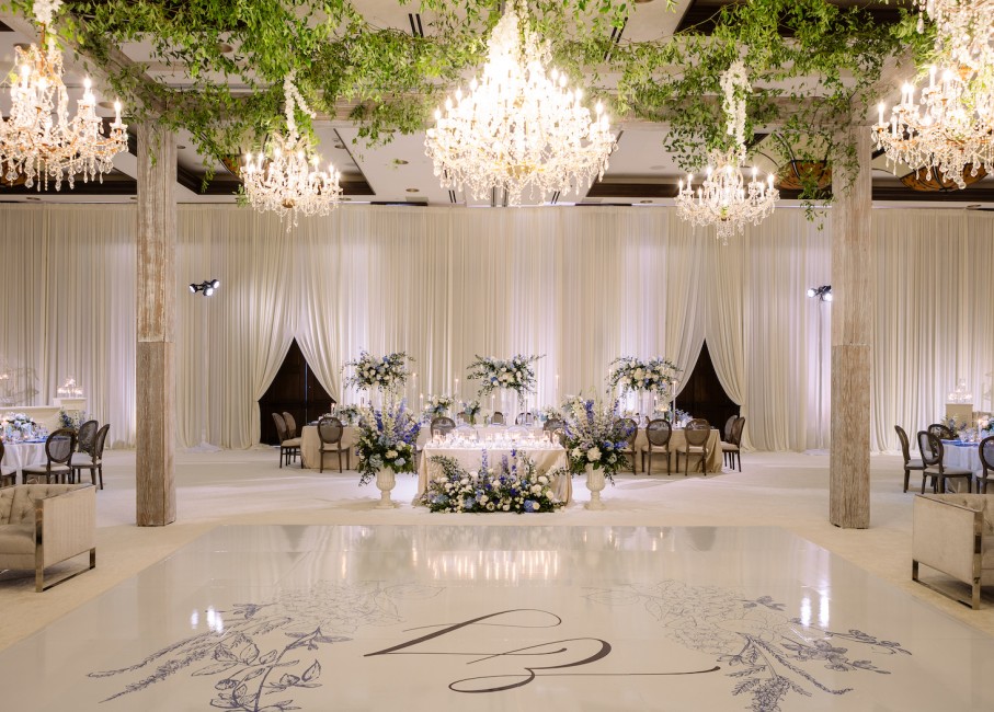 a wedding reception with chandeliers and flowers