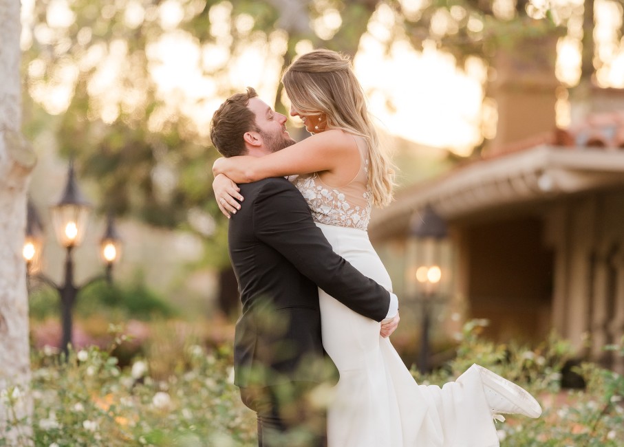 a man and woman kissing in a garden
