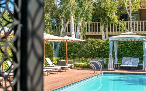 a pool with chairs and umbrellas