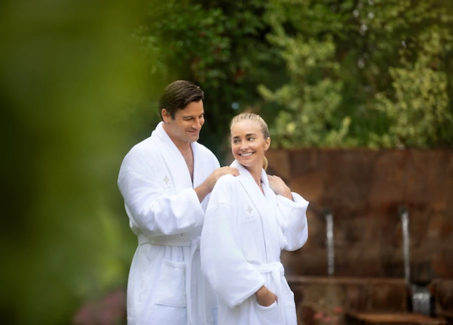 a man and woman wearing white robes