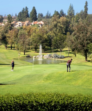 a man and woman playing golf