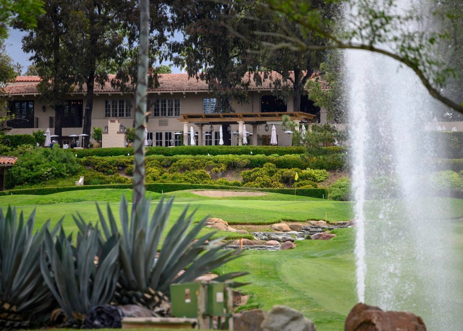 golf course with a small stream and water fountain on the course