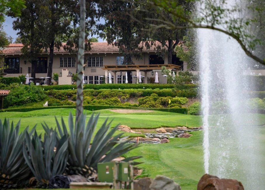 golf course with a small stream and water fountain on the course