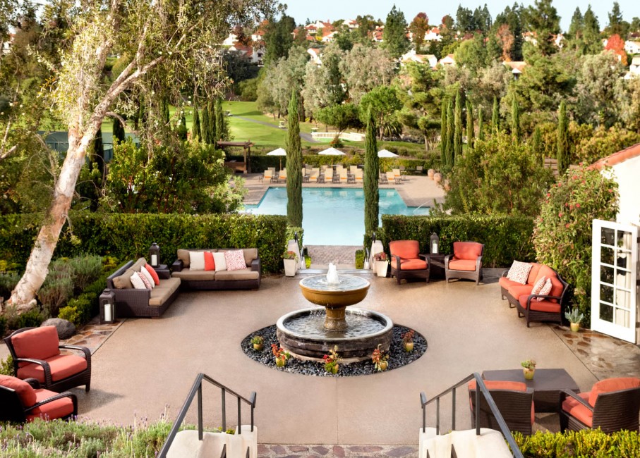 seating area set up near and around the pool and the water fountain