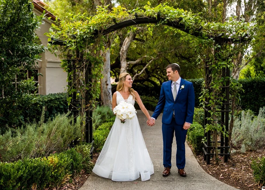 Couple holding hands on their wedding day.